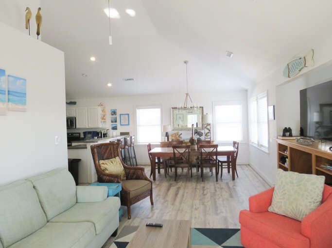 Bright, Spacious Living Area With Varied Seating, Kitchen In Back, White Walls