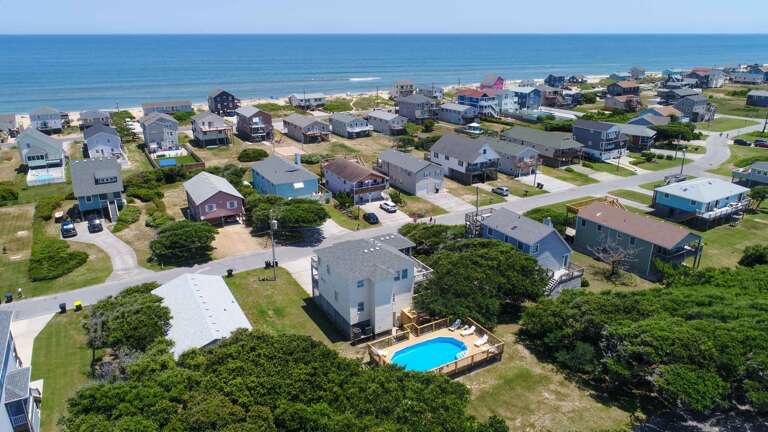 Seaside Residential Area With Houses And A Swimming Pool Near The Beach