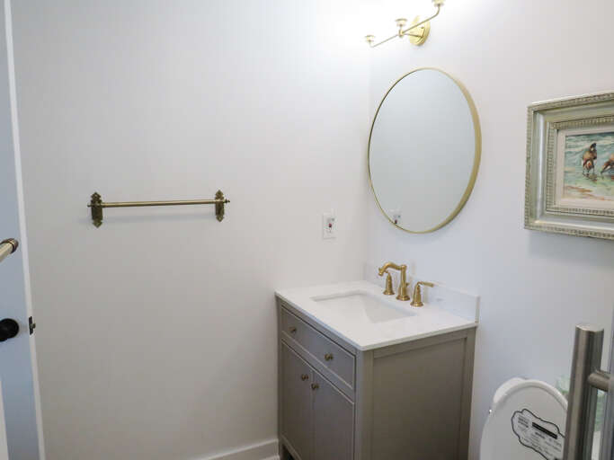 Small Space Showing Sink And Mirror, Muted Tones Throughout