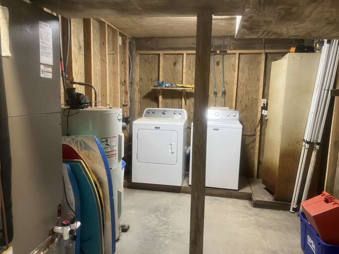 Located on the ground level under the home, this laundry room features full sized appliances for your convenience.