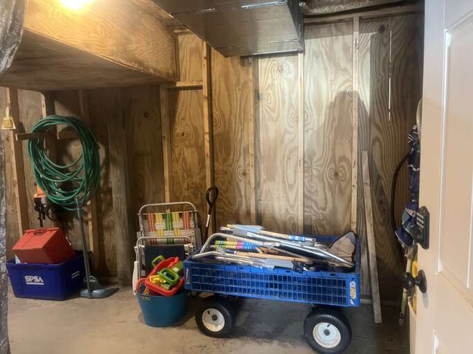 Located on the ground level under the home, this laundry room also has a few beach chairs and wagon for your convenience.