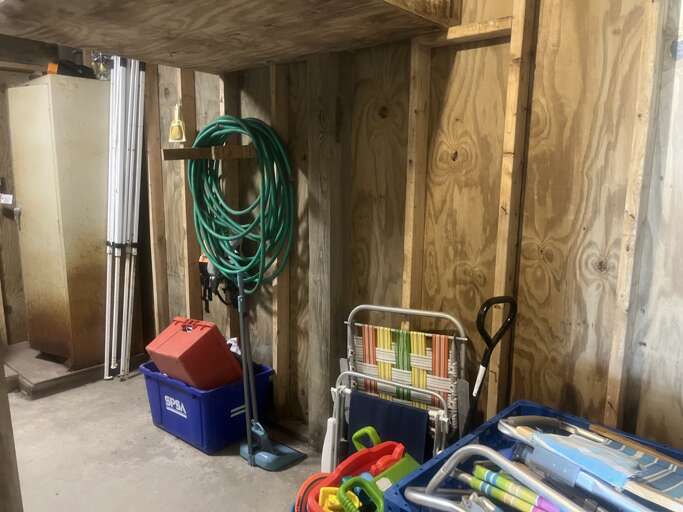 Located on the ground level under the home, this laundry room also has a few beach chairs and wagon for your convenience.