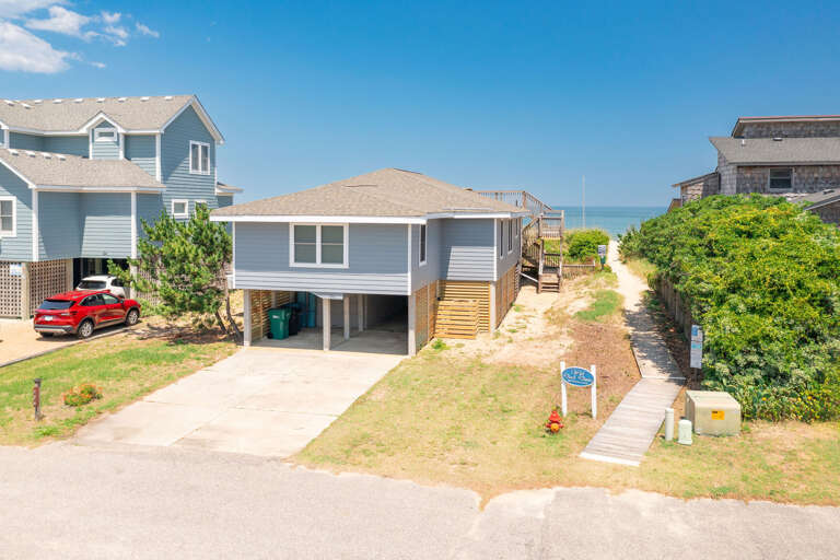 Beachside Residential Area With Pathway Leading To The Sea