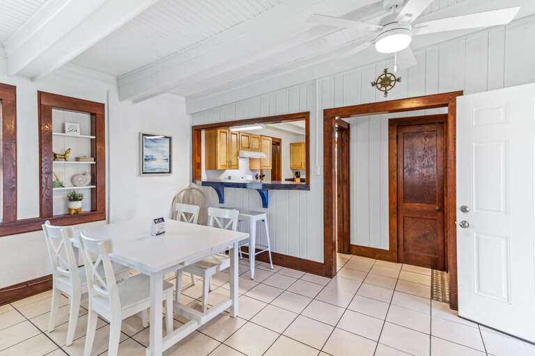 Interior Of A Vacation Rental Dining Area With Adjoining Kitchen
