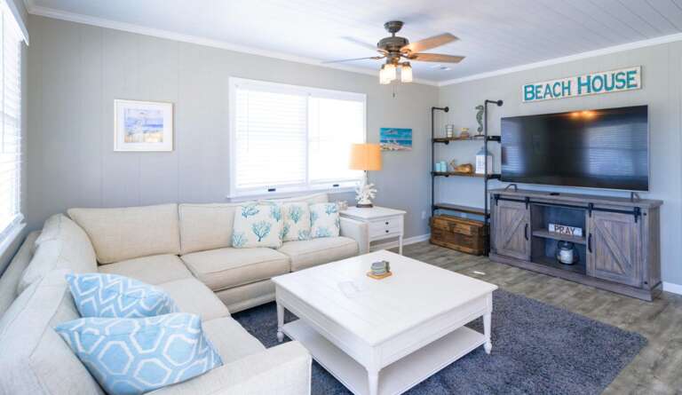 Living Room With Sectional Sofa, Coffee Table, And TV