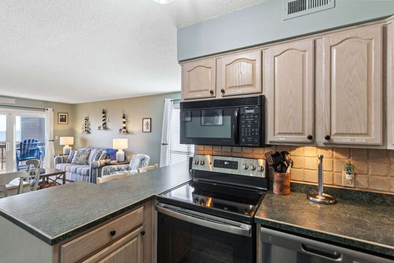 Black and stainless appliances, tons of counter space and a view this kitchen is sure to delight any cook.