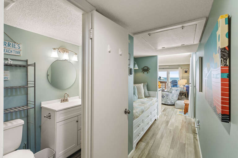 Light-filled Vacation Rental Interior With Sea-themed Decor Leading To A Balcony