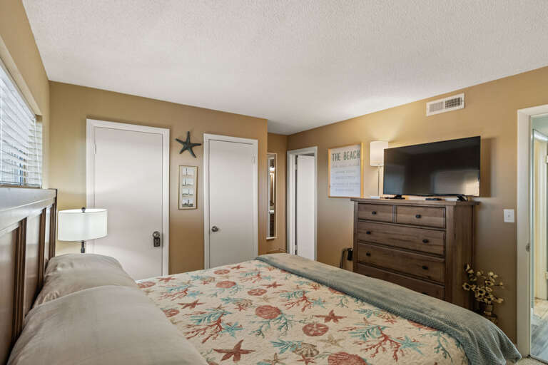 Just to the left of the bathroom this King bedroom is tucked away for privacy and enveloped in comfort.