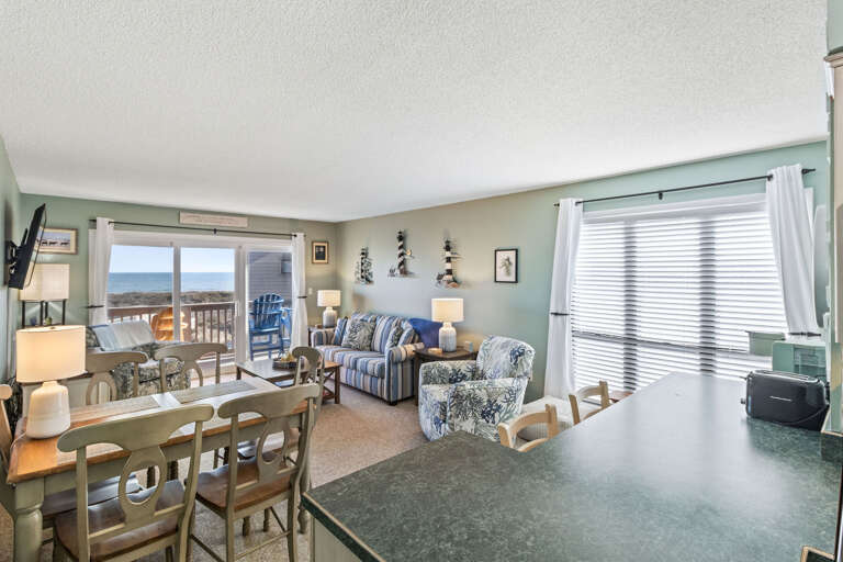 This living room offers sweeping ocean views and is thoughtfully decorated to create a welcoming, open space where you can truly unwind. Large windows allow natural light to flood the room, bringing the beauty of the ocean right inside. The tasteful decor