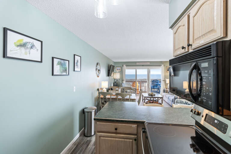 Black and stainless appliances, tons of counter space and a view this kitchen is sure to delight any cook.