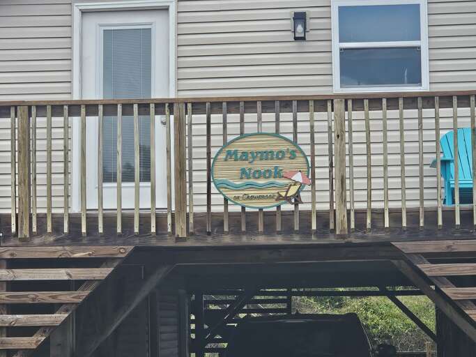 Wooden Walkway With Waymos Nook Signage On Building
