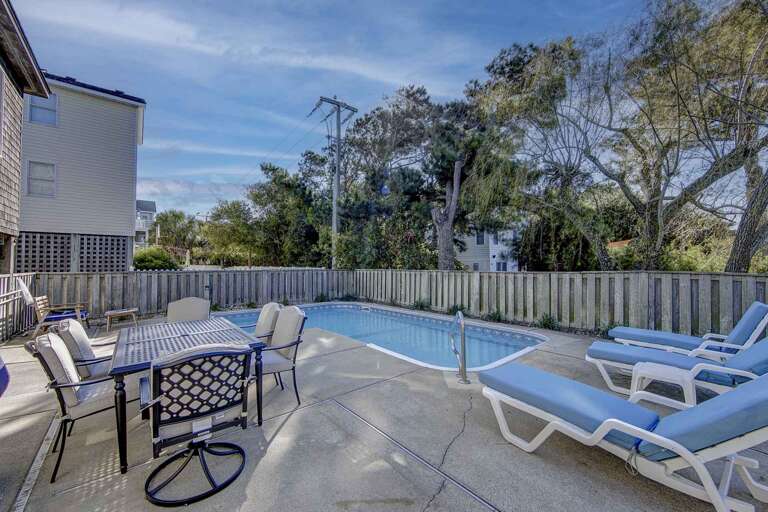 Poolside Patio, Loungers Lined Neatly, Dining Table Set Situated Aside Poolside Patio, Loungers Lined Neatly, Dining Table Set Situated Aside