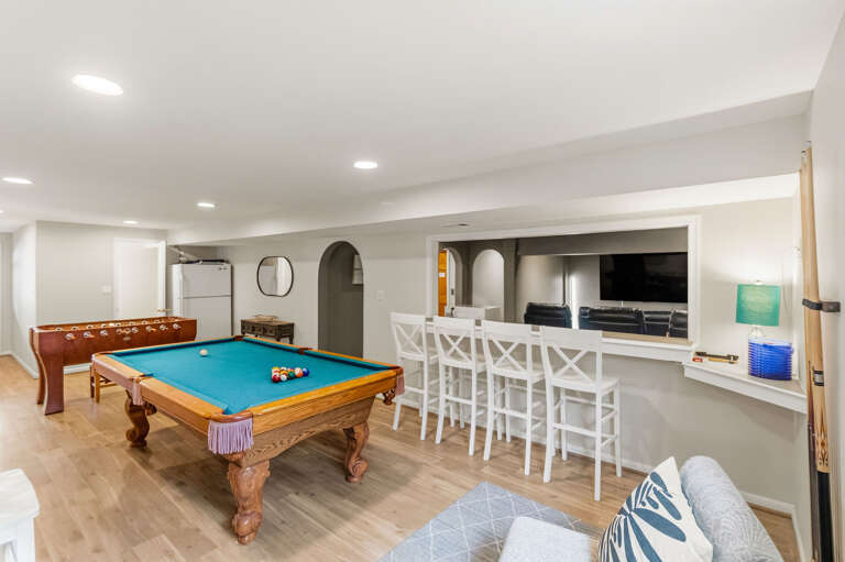 Game room with pool table and fooseball.