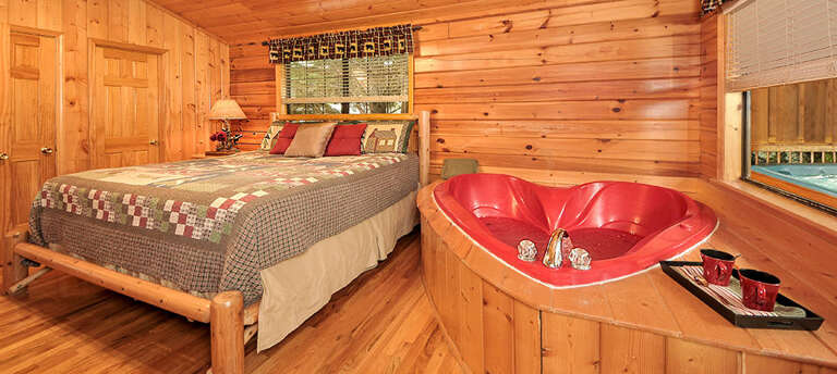 Wood-walled Room With Bed, Heart-shaped Bath, Wine Glasses