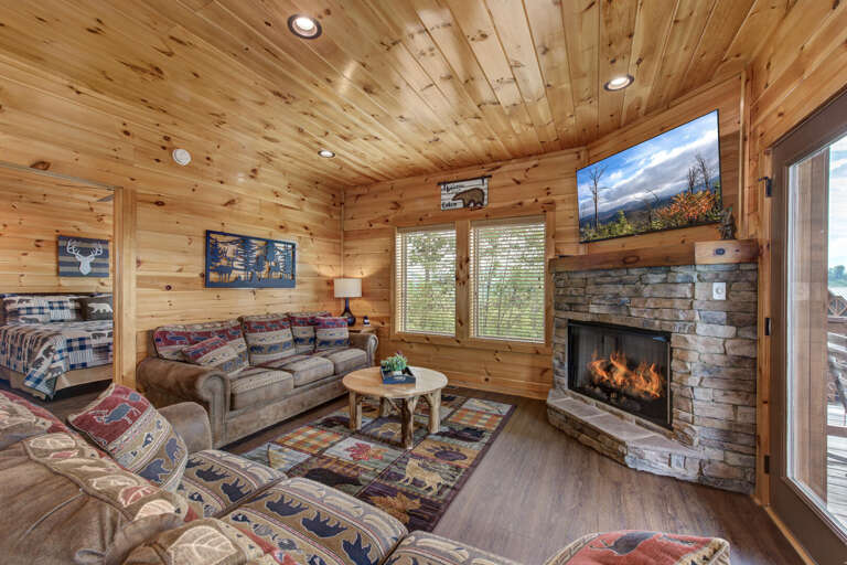 Rustic Rooms Roaring Fire, Rough-hewn Wood Walls, Resting Plush Sofas Under Radiant Mounted Screens