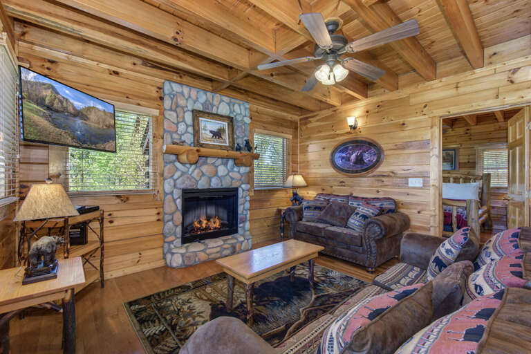 Rustic Room With Wooden Walls, Fireplace, And Mountain View