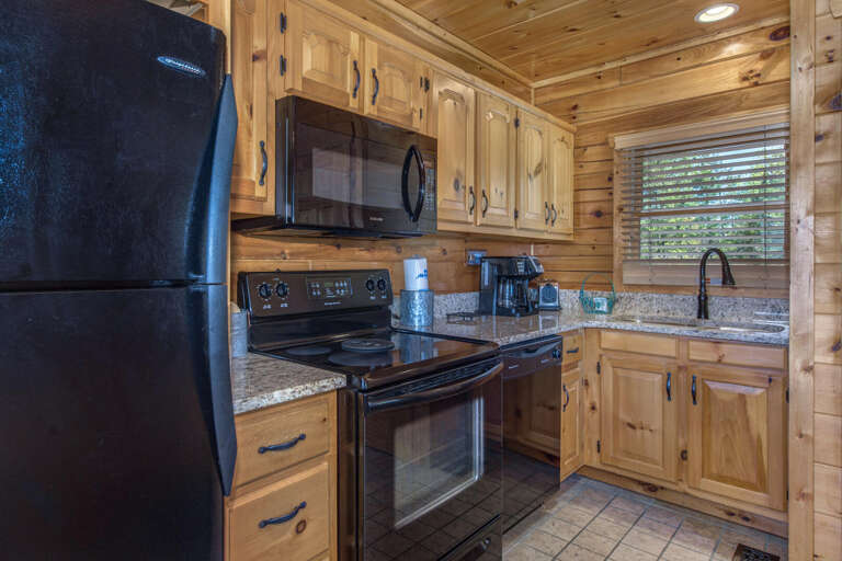 Rustic Rental Kitchen With Wooden Walls And Cabinets, Complete With Appliances
