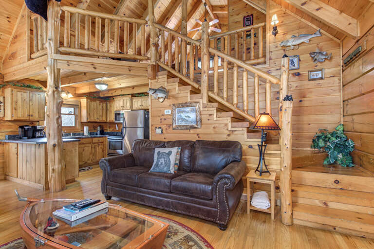 Wooden Vacation Rental Interior With Staircase And Plush Sofa