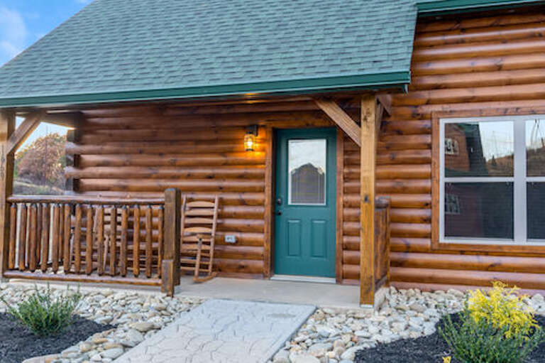 Rustic Log Cabin With Teal Door And Timber Porch Under Twilight