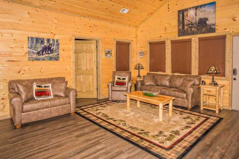 Wood-paneled Living Room With Sofas And Coffee Table In A Rustic Vacation Rental