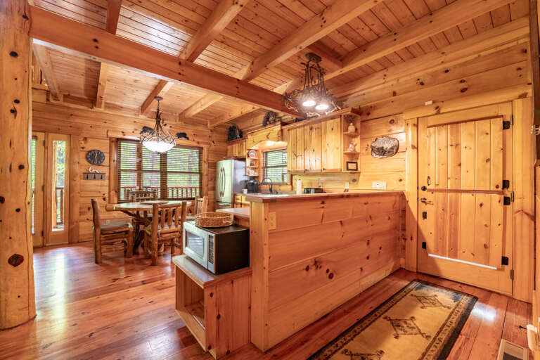 Pine-paneled Kitchen, Polished Wood Floors, Rustic Furnishings, Beam Ceiling