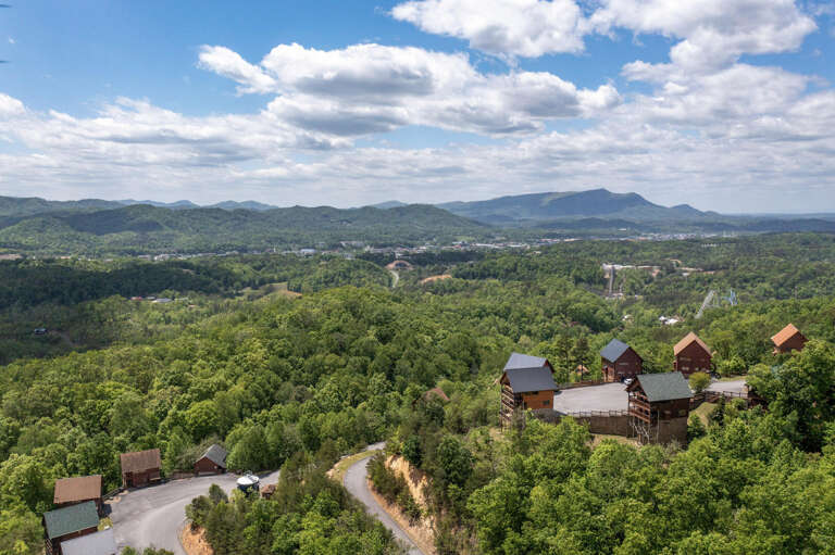 Rustic Retreats Nestled In Verdant Valley, Scenic Skyline Stretched Under Serene Skies