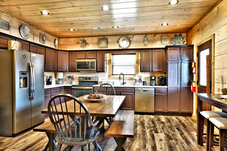 Wood-lined Kitchen With Stainless Steel Appliances And Spacious Seating Arrangement