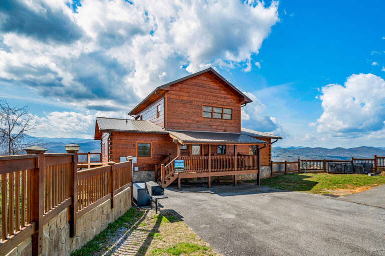 Wooden House Under Blue Skies, Bordered By Fences