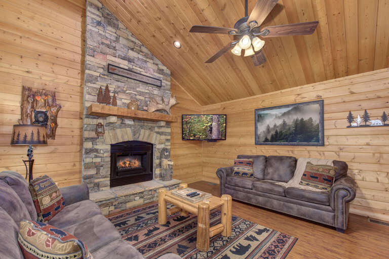 Rustic Room With Stone Fireplace And Wooden Walls