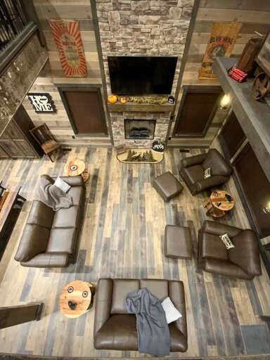 Lofty Living Lounge, Wood-paneled Walls, Plush Seating, Fireplace Focal Point