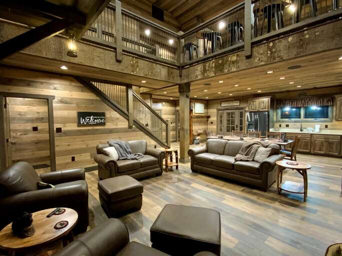 Spacious Wooden Living Space With Leather Sofas And Open Kitchen