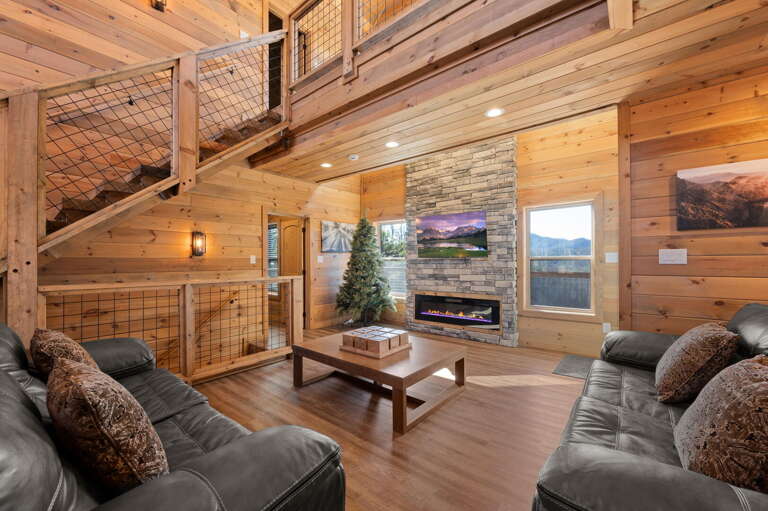 Rustic Retreat With Lofted Layout, Lush Sofas, And Log-lined Walls