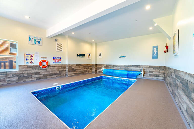 Indoor Pool, Blue Water, Beige Floor, Stone Walls