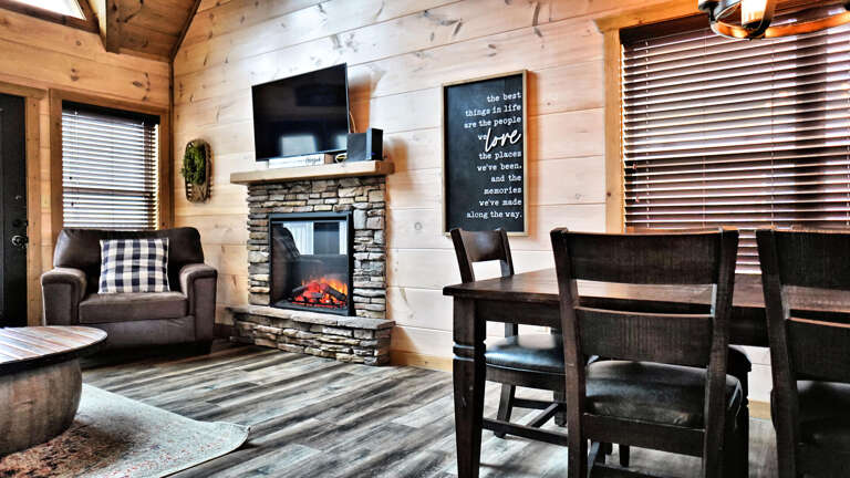 Rustic Vacation Rental Room With Fireplace And Wooden Furniture
