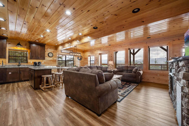 Spacious, Wooden Lodge Living Space With Sofas And Kitchen