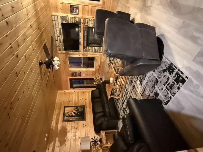 Wood-paneled Living Space With Plush Seating And Polished Floors