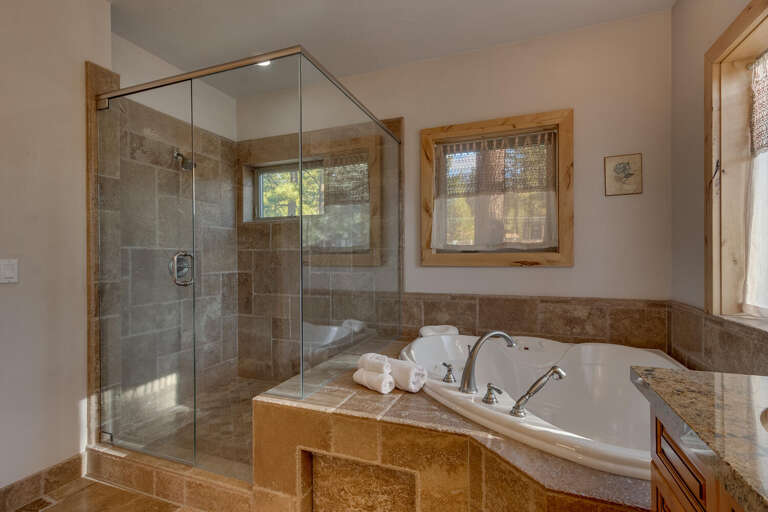 Bathroom with jetted tub and glass enclosed shower