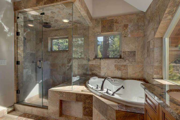 Bathroom with jetted tub and glass enclosed shower