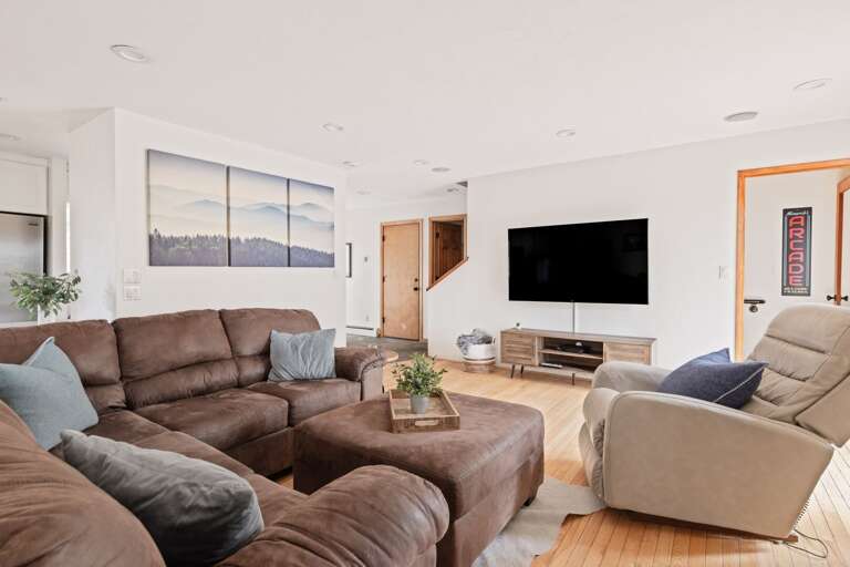 Living area with comfy couch, flat screen tv, and fireplace