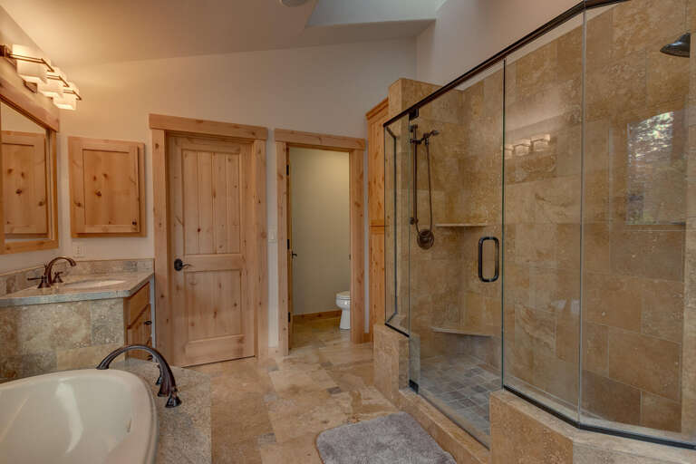 Bathroom with dual sinks, jetted tub, and large glass-enclosed shower