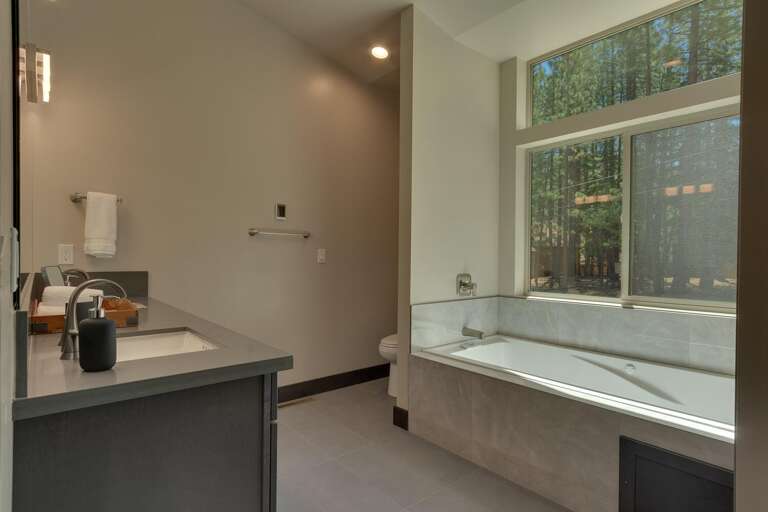 Bathroom with dual sinks, separate shower, and tub