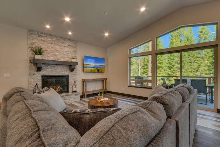 Living area with comfy sofa, fireplace, and flat screen tv