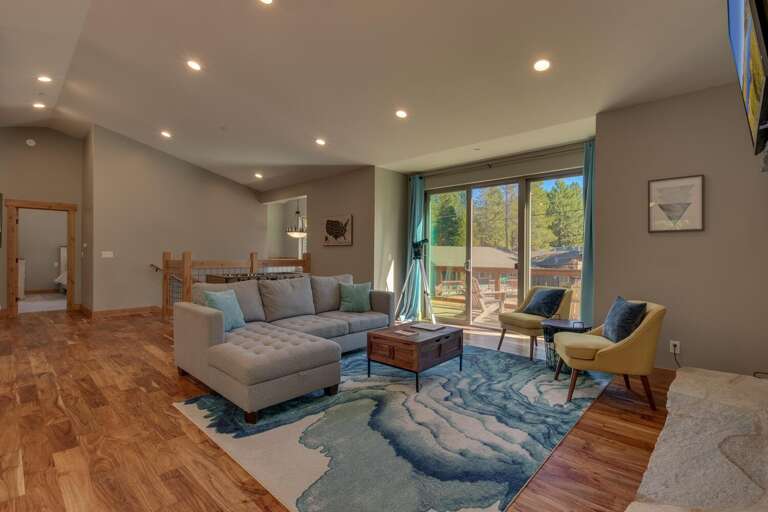 Living area with contemporary furniture, flat screen tv, fireplace, and foosball Living area with contemporary furniture, flat screen tv, fireplace, and foosball