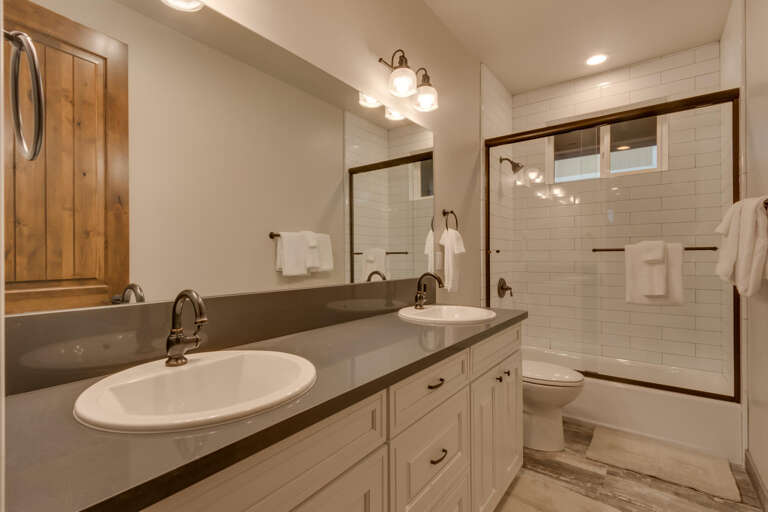 Bathroom with dual sinks and full bath and shower combo Bathroom with dual sinks and full bath and shower combo