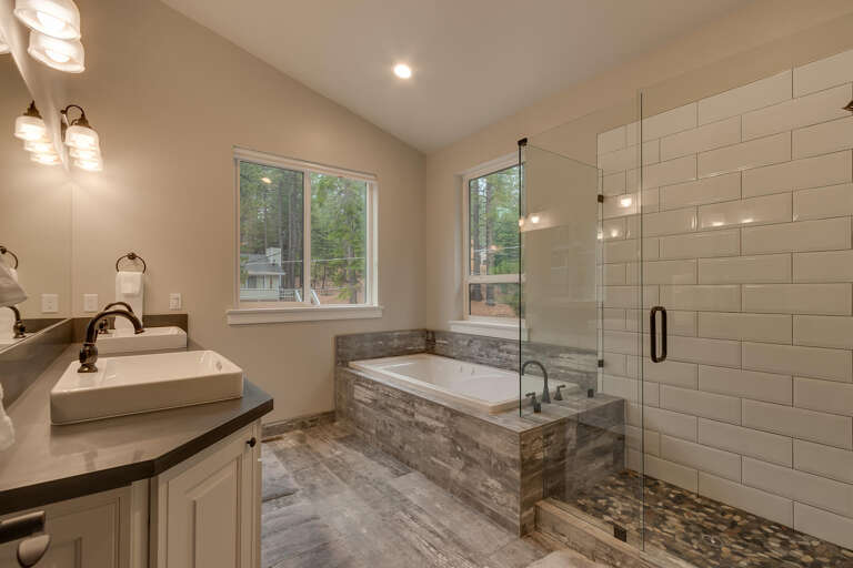 Bathroom with dual sinks, tub, and glass enclosed shower Bathroom with dual sinks, tub, and glass enclosed shower