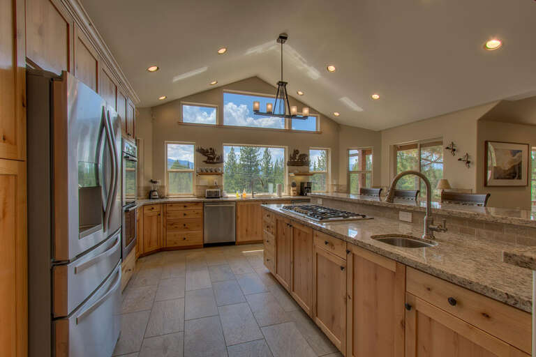 Expansive kitchen area with stainless-steel appliances and large islan