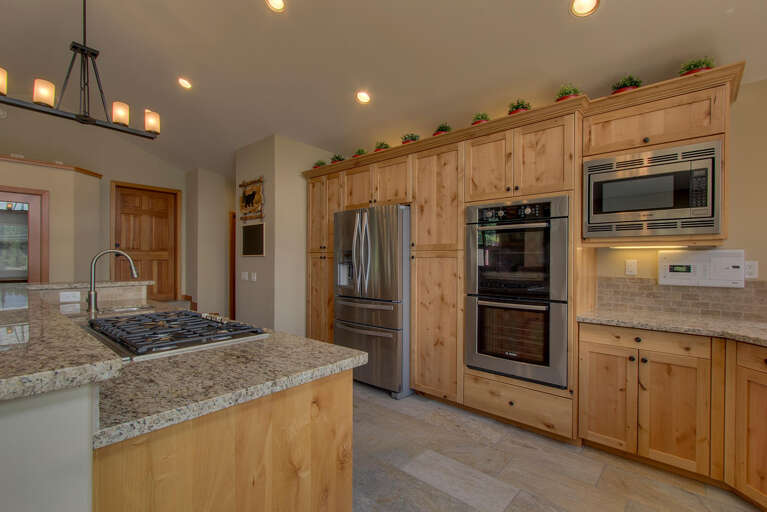 Expansive kitchen area with stainless-steel appliances and large island
