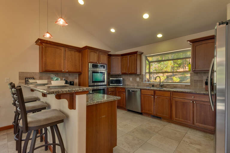 Kitchen area with stainless-steel appliances and spacious island Kitchen area with stainless-steel appliances and spacious island
