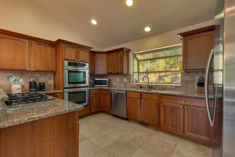 Kitchen area with stainless-steel appliances and spacious island Kitchen area with stainless-steel appliances and spacious island