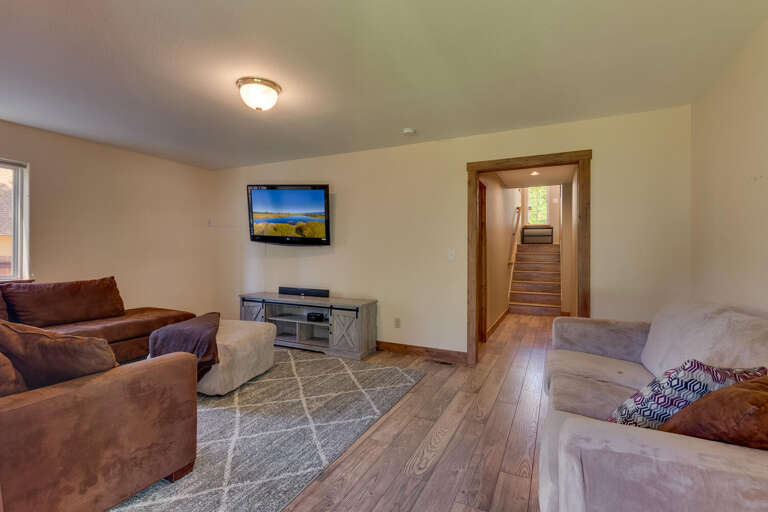 Downstairs living area with comfy couch and tv
